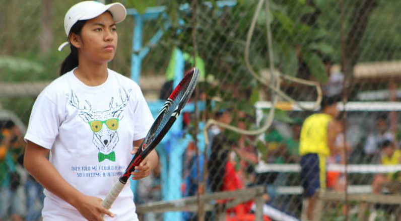 Elgy Dasian preparing to receive the ball from her opponent from NCR during the championship match in lawn tennis women.