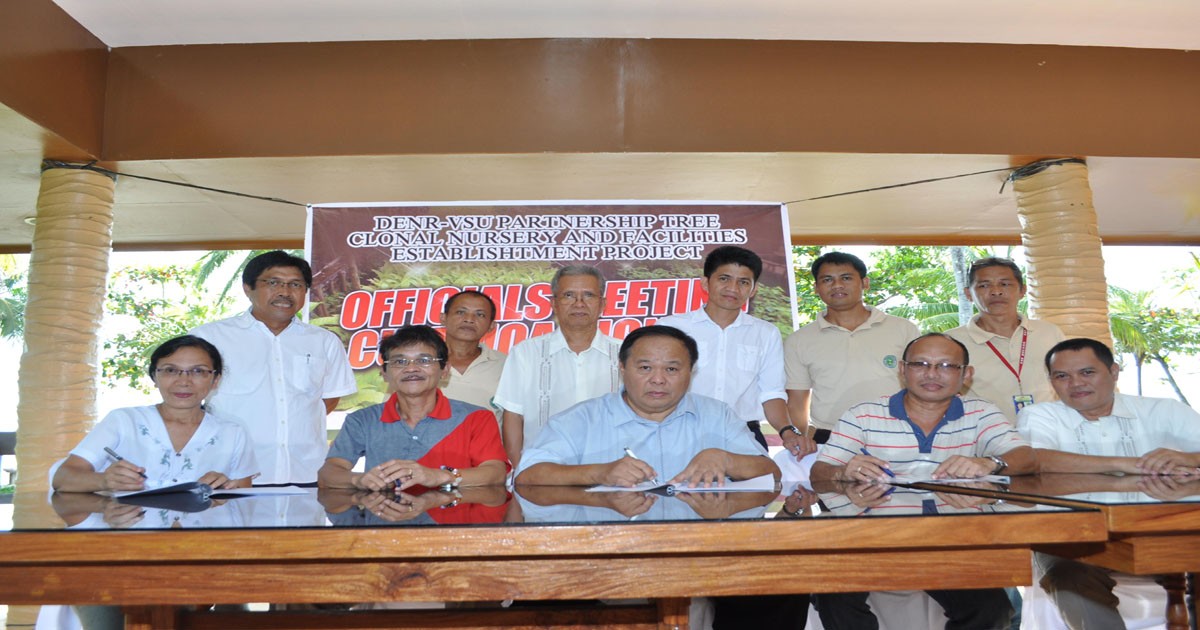 Dr. Jose L. Bacusmo (center, sitting) signing the MOA, together with Director Herminigildo C. Jocson of DENR-8 and Assoc. Prof. Rosa Ophelia D. Velarde (4th and 5th from right), in the presence of some CFES personnel. 