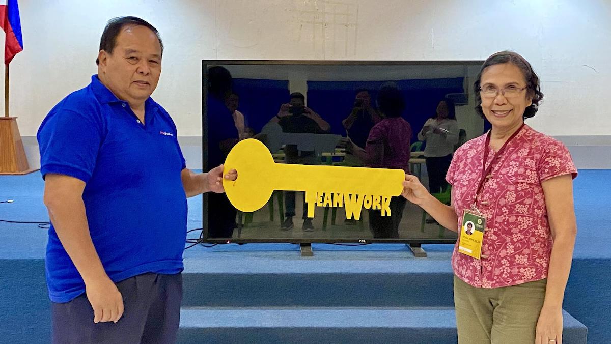 Dr. Jose Jose L. Bacusmo (left) bequeaths the ceremonial key to Prof. Rosa Ophelia D. Velarde (right) after being designated as the new Director for Research.