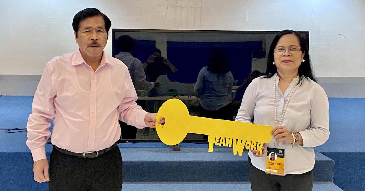 Dr. Maria Juliet C. Ceniza (right) receives the ceremonial key from Dr. Othello B. Capuno (left) symbolizing leadership transition in the Office of the Vice President for Research, Extension and Innovation (OVPREI).